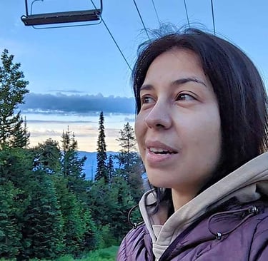 Woman enjoying the mountain views after returning home to Big White, British Columbia.