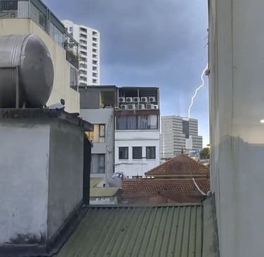 Lightning during thunderstorm outside apartment window in Hanoi Vietnam
