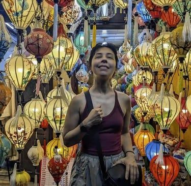 Standing among colorful lanterns in Hoi An, Vietnam