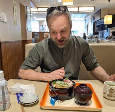Fresh Japanese seafood rice bowl served in a conveyor belt restaurant.