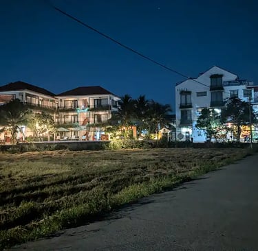 Quiet street and hotel buildings at night in Hoi An, Vietnam