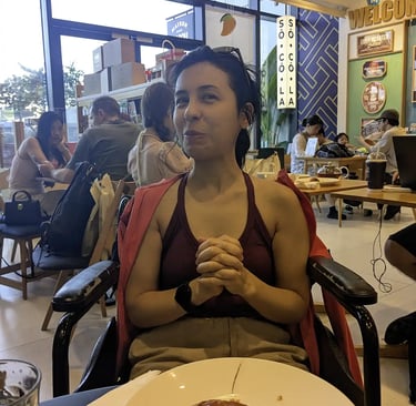 Person sitting in wheelchair at cafe inside Lotte Mall West Lake Hanoi in Hanoi Vietnam