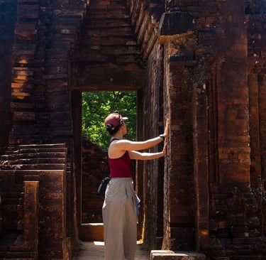 person touching temple wall inside my son sanctuary ruins vietnam