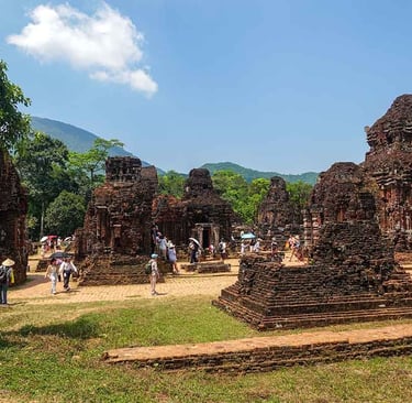 my son sanctuary ruins with mountains and tourists in hoi an vietnam