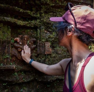 hand touching ancient carved temple wall at my son sanctuary vietnam