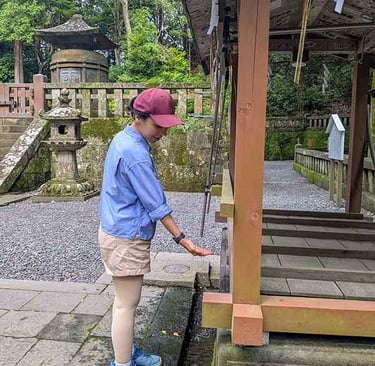 Traveler performing the purification ritual at a Japanese shrine.