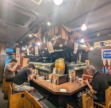 Interior of a traditional Japanese restaurant with diners enjoying a meal.