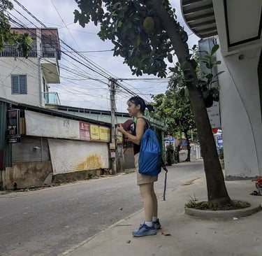Waiting for a ride on a quiet village street after visiting a pharmacy in northern Vietnam