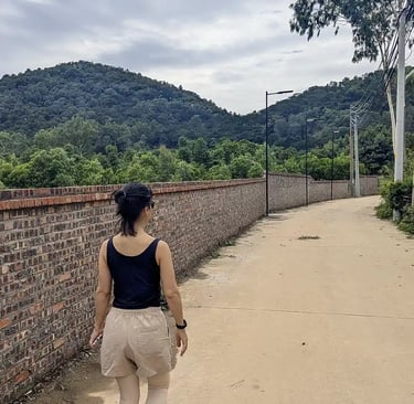 Walking near a retreat center surrounded by forested hills in northern Vietnam