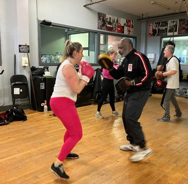 boxing instructor jon bottoms with boxing participant