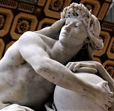 Classical marble sculpture of a man wearing a laurel wreath and holding a large vessel.