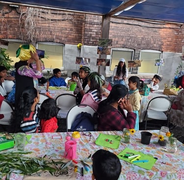 Children and families participate in an outdoor garden education workshop at a community urban farm.