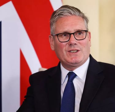 a man in a suit and tie with a british flag