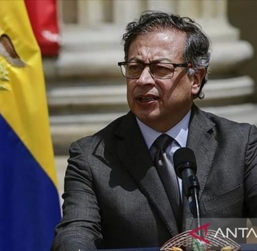 a man in a suit and tie is speaking into a microphone