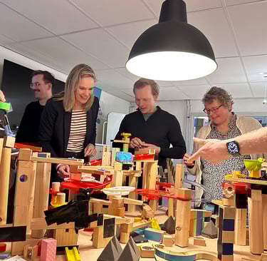 Colleagues collaborating on a systems thinking installation during a workshop.