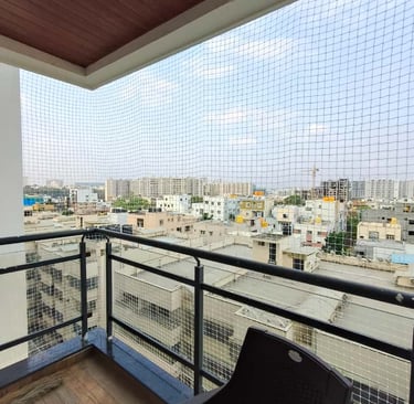 Side view of a balcony safety net installation showing secure anchoring points and neat finishing in