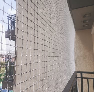 View of a balcony safety net protecting children playing safely indoors.