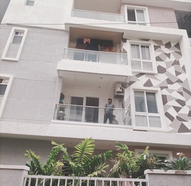 A close-up of a sturdy balcony safety net installed on a high-rise apartment in Chennai.