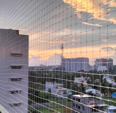 Technician from Arjilli Enterprises securing the netting around a duct opening.