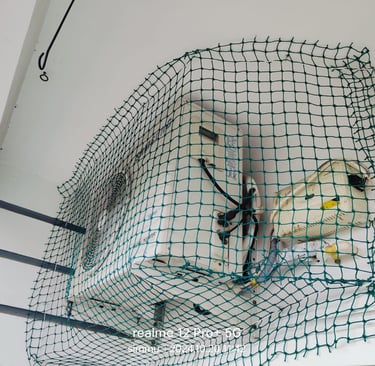 Close-up of a sturdy balcony pigeon net tightly secured on a Pallavaram apartment balcony.