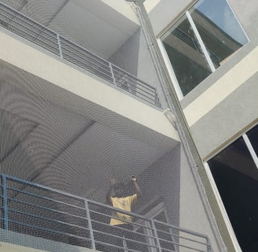 Technician from Arjilli Enterprises fitting the safety net with precision and care.