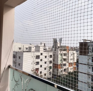 A child playing safely behind a balcony safety net, highlighting the protective barrier in a Velache
