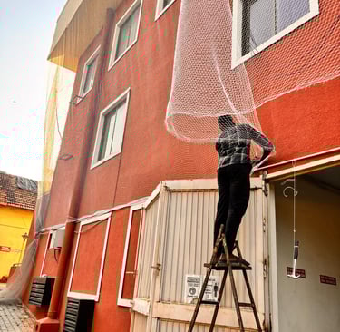 Close-up of a sturdy balcony net expertly fitted to protect against pigeons in a Chennai apartment.
