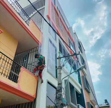 Side view of a balcony fully enclosed with pigeon netting, blending seamlessly with the building’s e