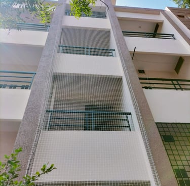 Close-up of durable pigeon netting installed on a balcony in OMR, Chennai, showing fine mesh and sec