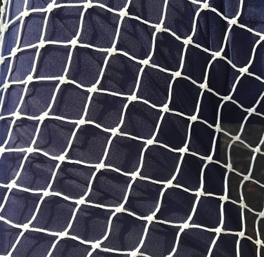 Detailed view of the net’s mesh pattern designed to keep pigeons out while allowing airflow.