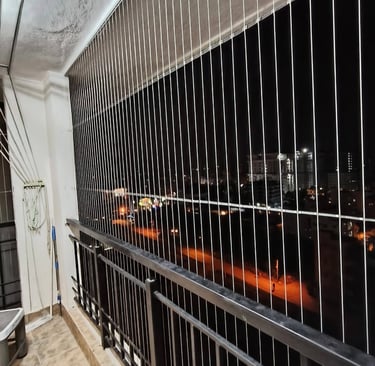 Evening photo capturing the subtle outline of invisible grills against a softly lit balcony.