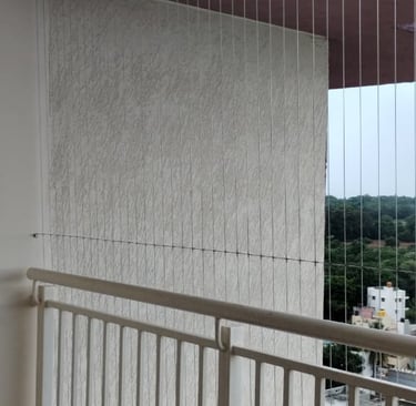 Wide shot of a modern apartment window fitted with invisible grills by Arjilli Enterprises.