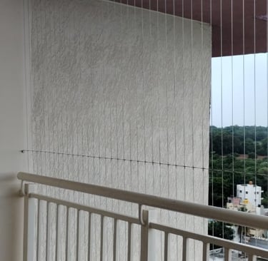Wide shot of a modern apartment window fitted with invisible grills by Arjilli Enterprises, blending