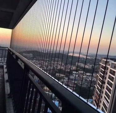 Close-up of a sleek invisible grill seamlessly installed on a Nungambakkam balcony, blending safety 
