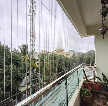 Close-up of a sleek invisible grill seamlessly installed on a Nungambakkam balcony, blending safety 