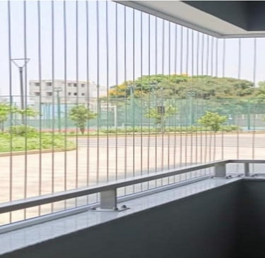 Daylight view showing the almost invisible safety grills on a Royapettah home window.