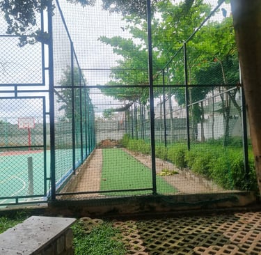 Hands tying knots on durable netting material, showcasing the craftsmanship behind each installation