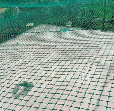 A football practice net anchored sturdily on a terrace with surrounding city view.