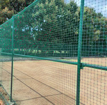 A panoramic shot capturing multiple sports nets installations across different fields, highlighting 