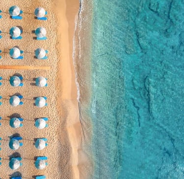 Aerial view of rows of beach umbrellas, Crete