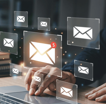 Professional person using a laptop with digital email icons and notifications for business communication.