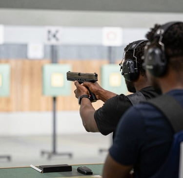 Group photo of diverse students proudly holding certificates after completing a women’s firearms course.