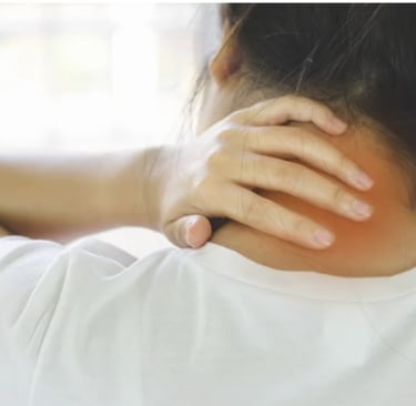 A woman holding her neck in pain, highlighting symptoms of neck strain and cervical spine discomfort.