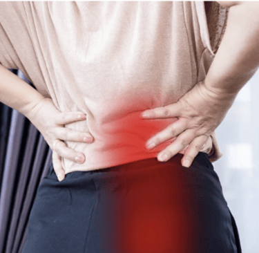 A person holding their lower back and hip due to chronic muscle pain and sciatica.
