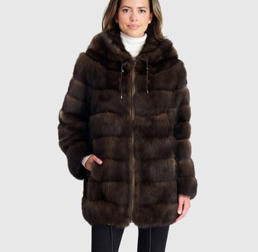 a woman in a brown gorski coat with a hoodie