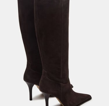 a pair of Alaia boots with a high heel and a high heel