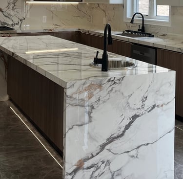 Close-up of a seamless 45-degree mitered edge on a Calacatta Sintered Stone island by Maple Style Li