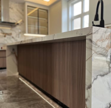 Close-up of a seamless 45-degree mitered edge on a Calacatta Sintered Stone island by Maple Style Li