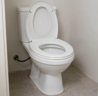 White ceramic flush toilet with an open lid in a modern bathroom with grey tile flooring.