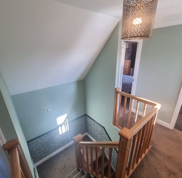 A finished landing and stairway in a residential home.